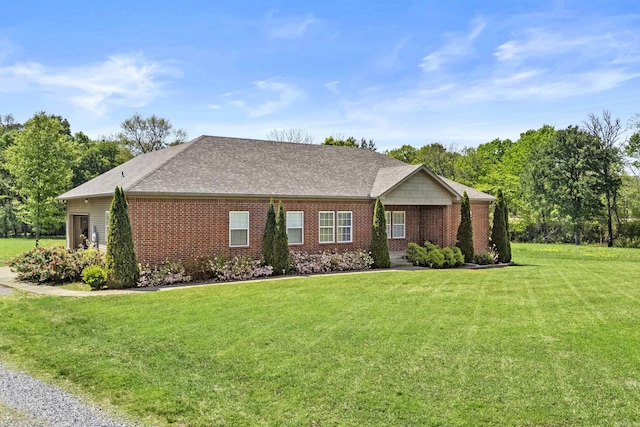 single story home with a front lawn and brick siding