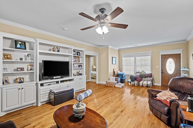 living room featuring ceiling fan, baseboards, ornamental molding, and light wood-style flooring