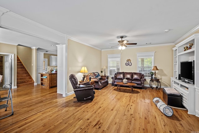 living room with baseboards, light wood-style floors, a ceiling fan, stairway, and ornamental molding