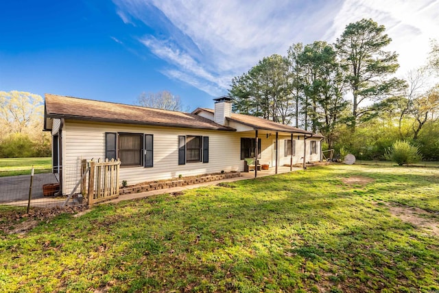 2002 W Maddox Rd, Jacksonville, AR 72076 - back of house with a yard, a chimney, and a patio