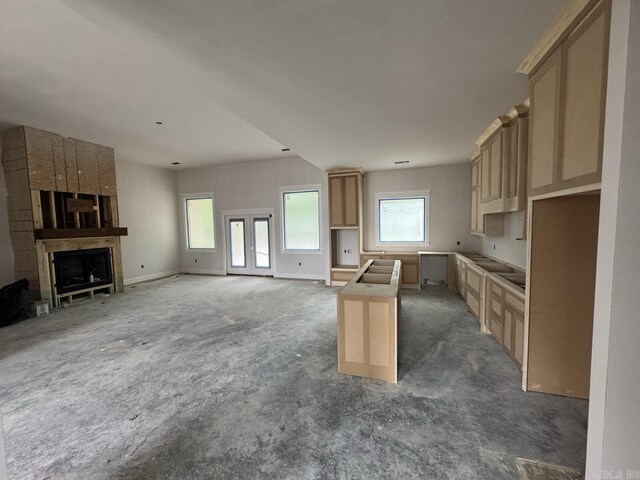 121 Panorama Dr, Hot Springs Village, AR 71909 - kitchen with carpet, a center island, a fireplace, open floor plan, and baseboards