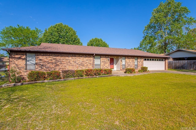 ranch-style house featuring fence, aphalt driveway, a front yard, and a garage