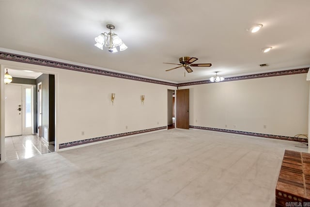 unfurnished living room with crown molding, baseboards, and ceiling fan with notable chandelier