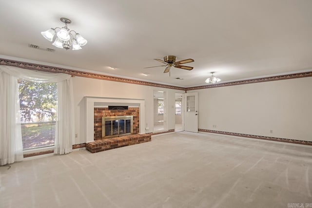 unfurnished living room with light colored carpet, a wealth of natural light, visible vents, and ceiling fan with notable chandelier