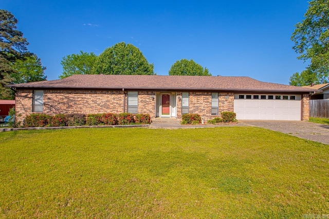 ranch-style home with a front lawn, driveway, an attached garage, fence, and brick siding
