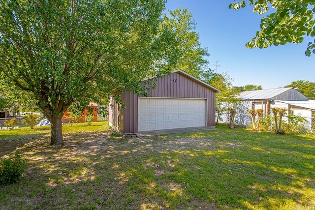 detached garage featuring fence