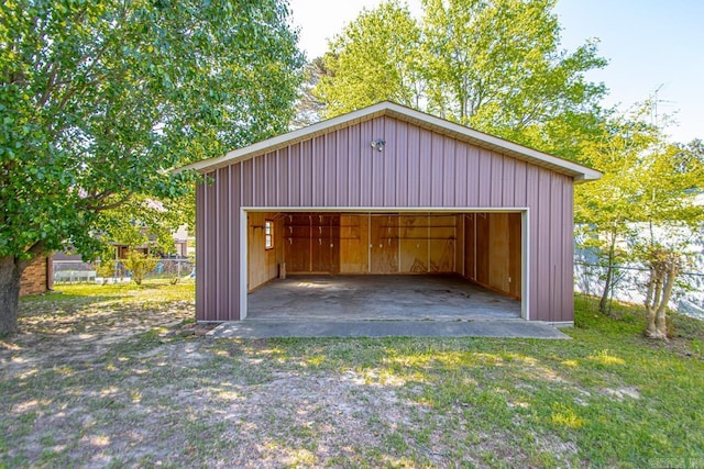 detached garage featuring fence