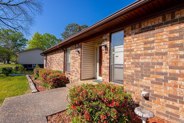 doorway to property with brick siding