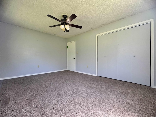 unfurnished bedroom with carpet flooring, a textured ceiling, visible vents, baseboards, and a closet