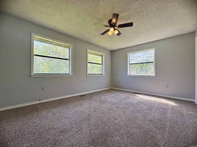 unfurnished room featuring baseboards, a ceiling fan, a textured ceiling, and carpet