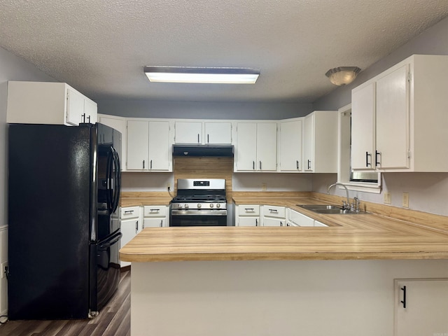 kitchen with a sink, dark wood finished floors, stainless steel gas range, black refrigerator with ice dispenser, and under cabinet range hood