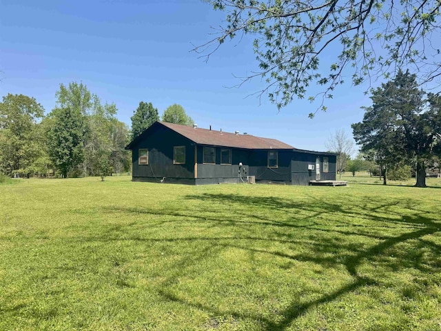 rear view of property with a lawn