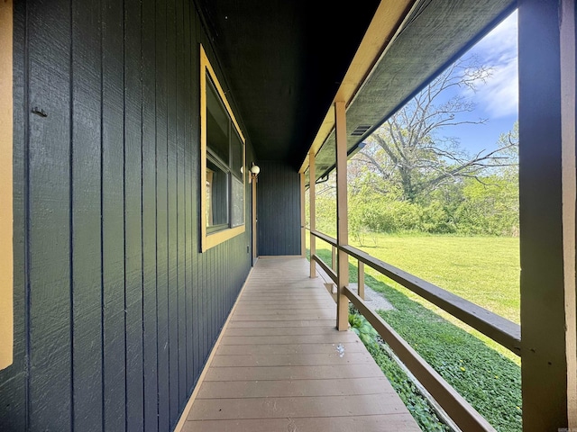 wooden deck featuring a yard