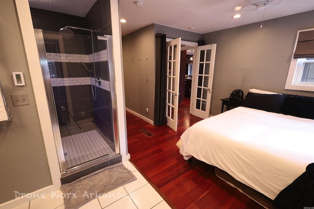bedroom with french doors, wood finished floors, visible vents, and recessed lighting