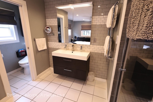 full bathroom with a wealth of natural light, toilet, vanity, and a stall shower