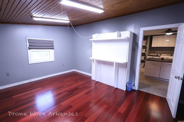 empty room featuring baseboards and dark wood-type flooring