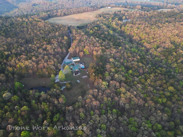 drone / aerial view featuring a forest view