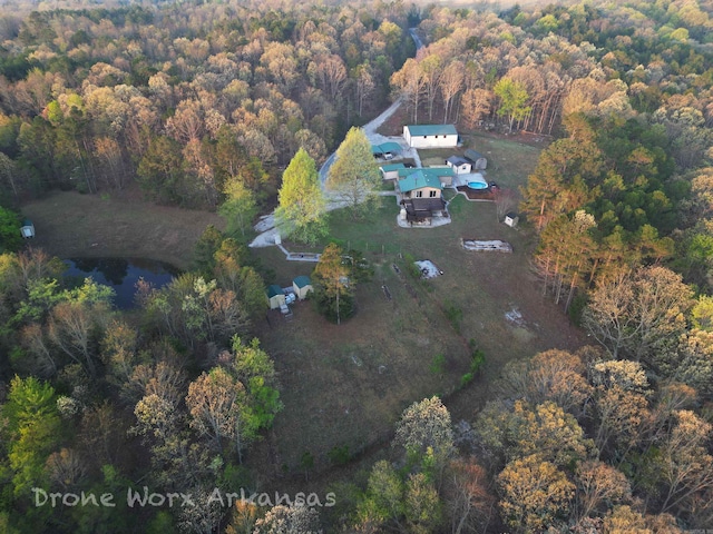 drone / aerial view featuring a view of trees and a water view