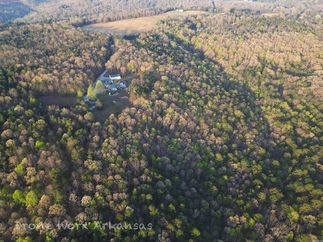 birds eye view of property featuring a view of trees
