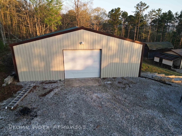 detached garage with gravel driveway
