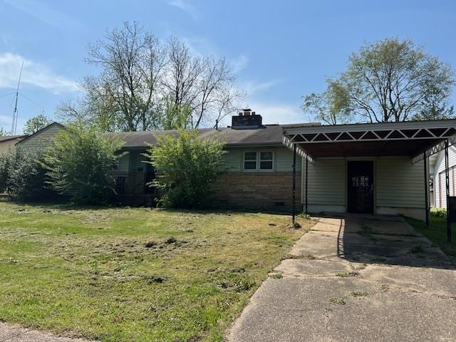 ranch-style home featuring a chimney, a front lawn, driveway, an attached carport, and brick siding