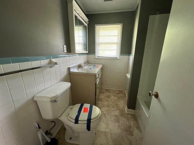 full bathroom featuring a washtub, wainscoting, tile walls, walk in shower, and toilet