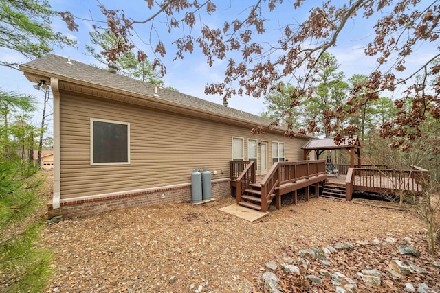 back of house with a wooden deck