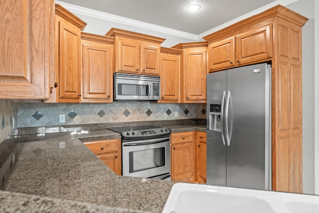 kitchen with ornamental molding, appliances with stainless steel finishes, and tasteful backsplash