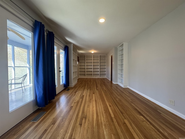 21 Belmont Dr, Little Rock, AR 72204 - empty room featuring baseboards, wood finished floors, visible vents, and built in shelves