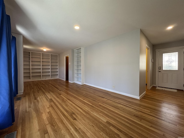 21 Belmont Dr, Little Rock, AR 72204 - interior space featuring baseboards, visible vents, built in shelves, and hardwood / wood-style flooring