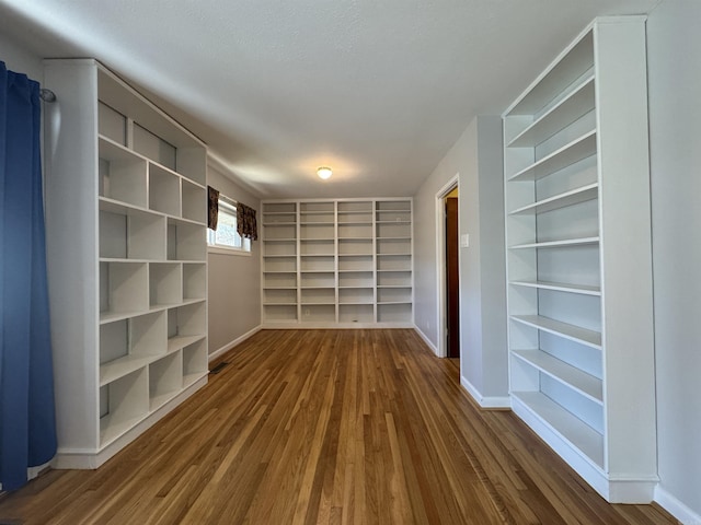 21 Belmont Dr, Little Rock, AR 72204 - spare room featuring built in shelves, baseboards, and dark wood-type flooring