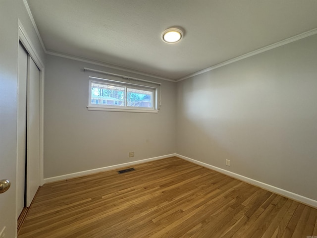 21 Belmont Dr, Little Rock, AR 72204 - unfurnished bedroom featuring crown molding, light wood-style flooring, visible vents, and a closet