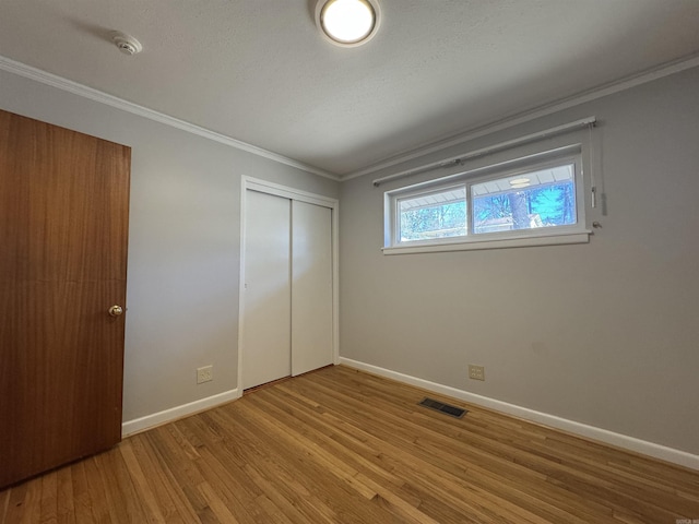 21 Belmont Dr, Little Rock, AR 72204 - unfurnished bedroom with wood finished floors, visible vents, baseboards, and ornamental molding