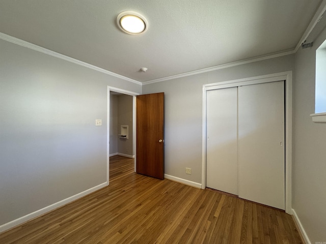 21 Belmont Dr, Little Rock, AR 72204 - unfurnished bedroom with baseboards, wood finished floors, a closet, and ornamental molding