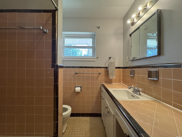 21 Belmont Dr, Little Rock, AR 72204 - bathroom featuring toilet, tile walls, wainscoting, tile patterned flooring, and vanity