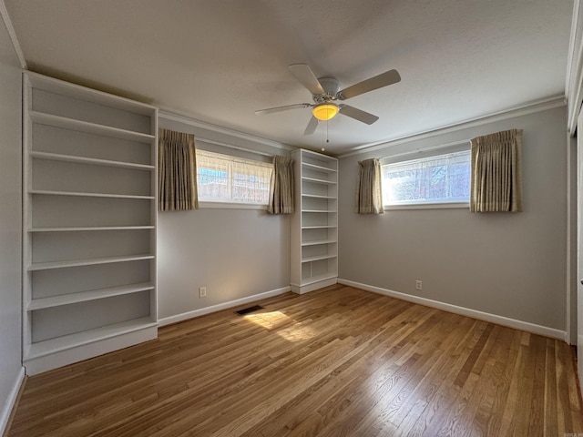 21 Belmont Dr, Little Rock, AR 72204 - unfurnished bedroom with wood finished floors, visible vents, baseboards, and ornamental molding