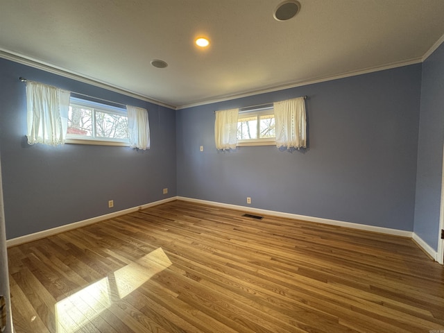 21 Belmont Dr, Little Rock, AR 72204 - unfurnished room with a wealth of natural light, crown molding, wood finished floors, and visible vents