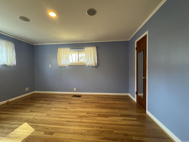 21 Belmont Dr, Little Rock, AR 72204 - spare room with baseboards, wood finished floors, visible vents, and crown molding