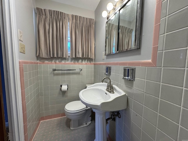 21 Belmont Dr, Little Rock, AR 72204 - half bathroom featuring tile patterned flooring, a wainscoted wall, toilet, a sink, and tile walls