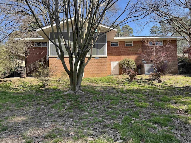 21 Belmont Dr, Little Rock, AR 72204 - view of home's exterior featuring a sunroom and brick siding