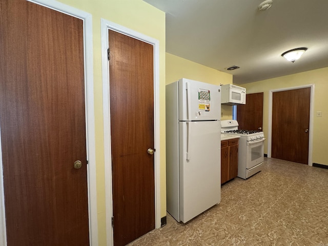 21 Belmont Dr, Little Rock, AR 72204 - kitchen with light floors, light countertops, visible vents, and white appliances