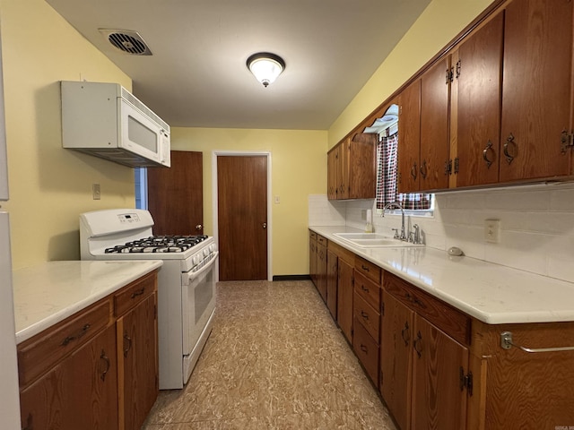 21 Belmont Dr, Little Rock, AR 72204 - kitchen featuring visible vents, a sink, white appliances, and light countertops