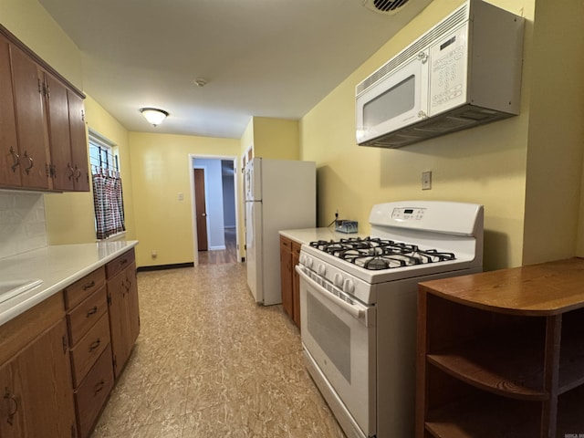 21 Belmont Dr, Little Rock, AR 72204 - kitchen with light floors, light countertops, visible vents, white appliances, and tasteful backsplash