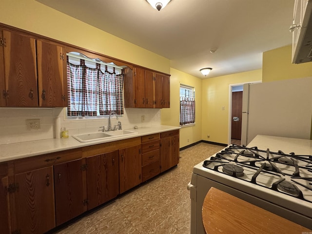 21 Belmont Dr, Little Rock, AR 72204 - kitchen with light countertops, a sink, white appliances, and plenty of natural light