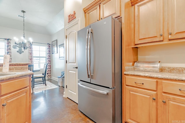 6037 Beaver Creek Ln, Jones Creek, AR 72404 - kitchen with light brown cabinetry, light countertops, visible vents, freestanding refrigerator, and a notable chandelier