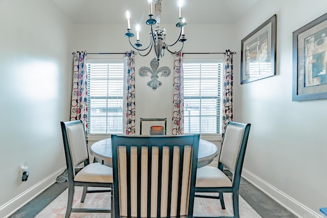 6037 Beaver Creek Ln, Jones Creek, AR 72404 - carpeted dining area featuring baseboards and a notable chandelier