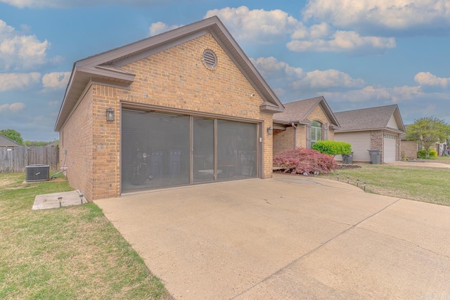 6037 Beaver Creek Ln, Jones Creek, AR 72404 - view of front facade with concrete driveway, a front lawn, central air condition unit, a garage, and brick siding