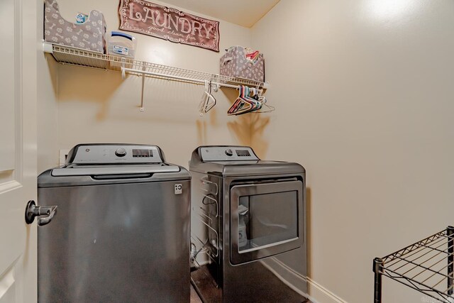 6037 Beaver Creek Ln, Jones Creek, AR 72404 - laundry room with washer and dryer, baseboards, and laundry area