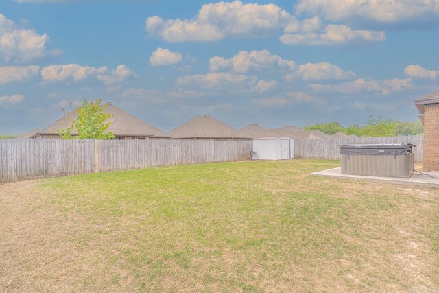 6037 Beaver Creek Ln, Jones Creek, AR 72404 - view of yard with a fenced backyard, a hot tub, an outbuilding, and a storage shed