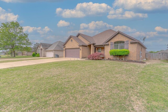 6037 Beaver Creek Ln, Jones Creek, AR 72404 - ranch-style house featuring fence, a front lawn, driveway, brick siding, and a garage